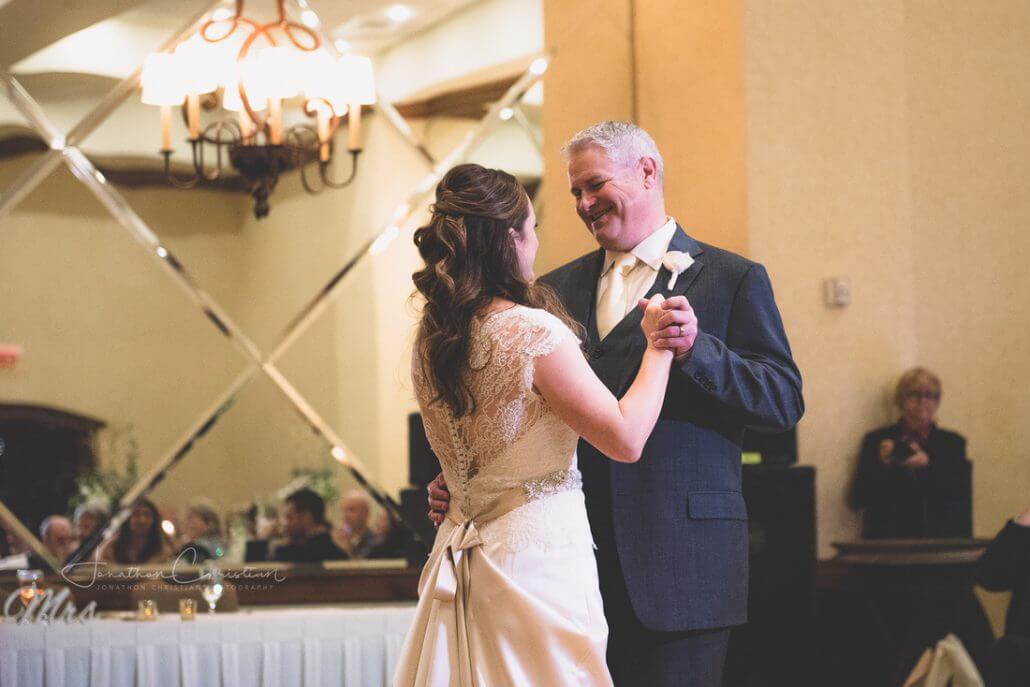 Fort Worth wedding photography by Toast: a bride and an older man, likely her father, share a dance at a wedding reception in a warmly lit banquet hall.