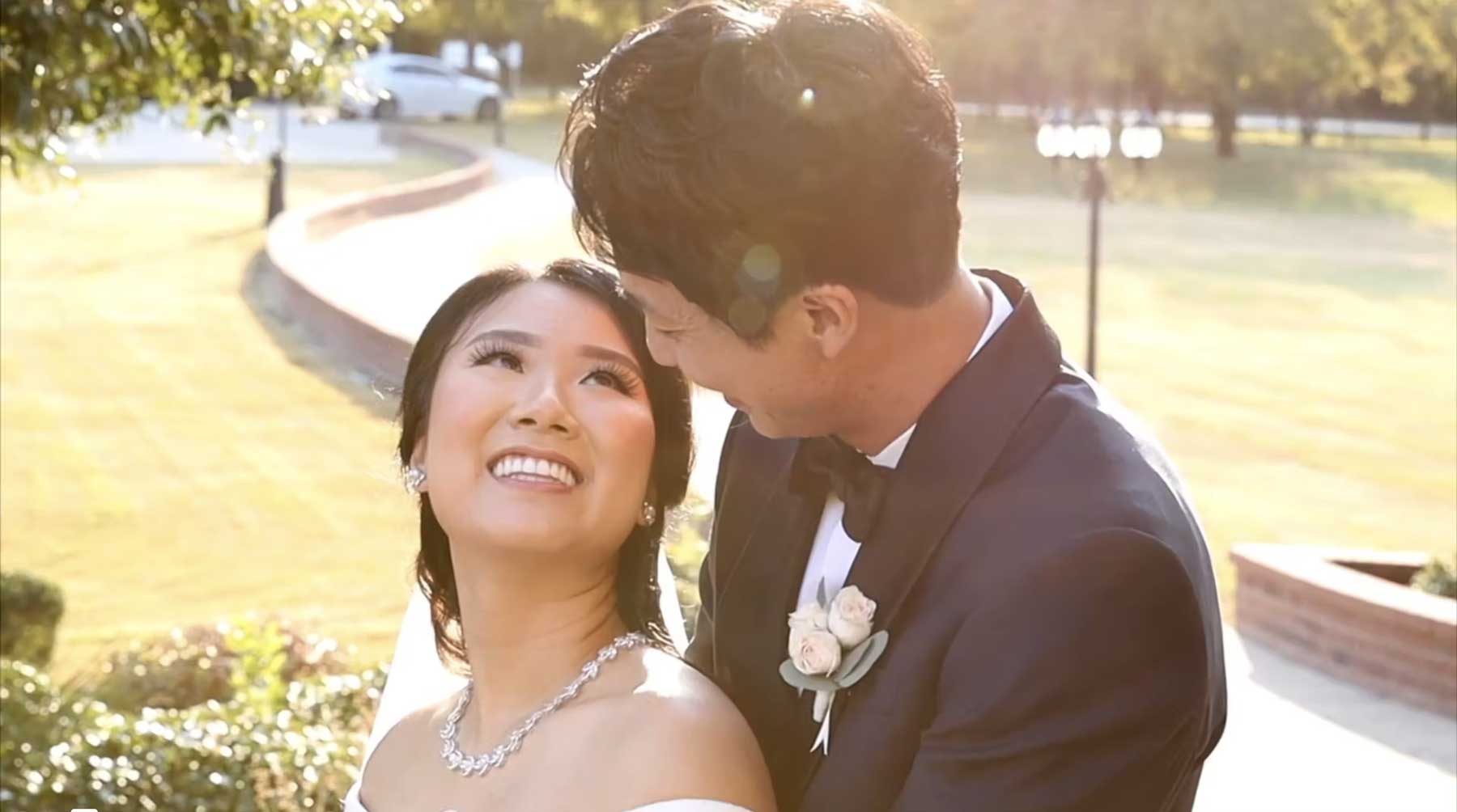 Bride and groom smiling at each other in the sunlight beside the river in Fort Worth, a still from their Toast wedding film
