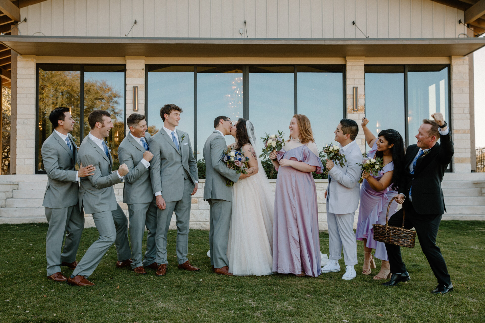 Full wedding party on the lawn outside the Stonehouse Villa Reception Hall, Driftwood TX wedding venue