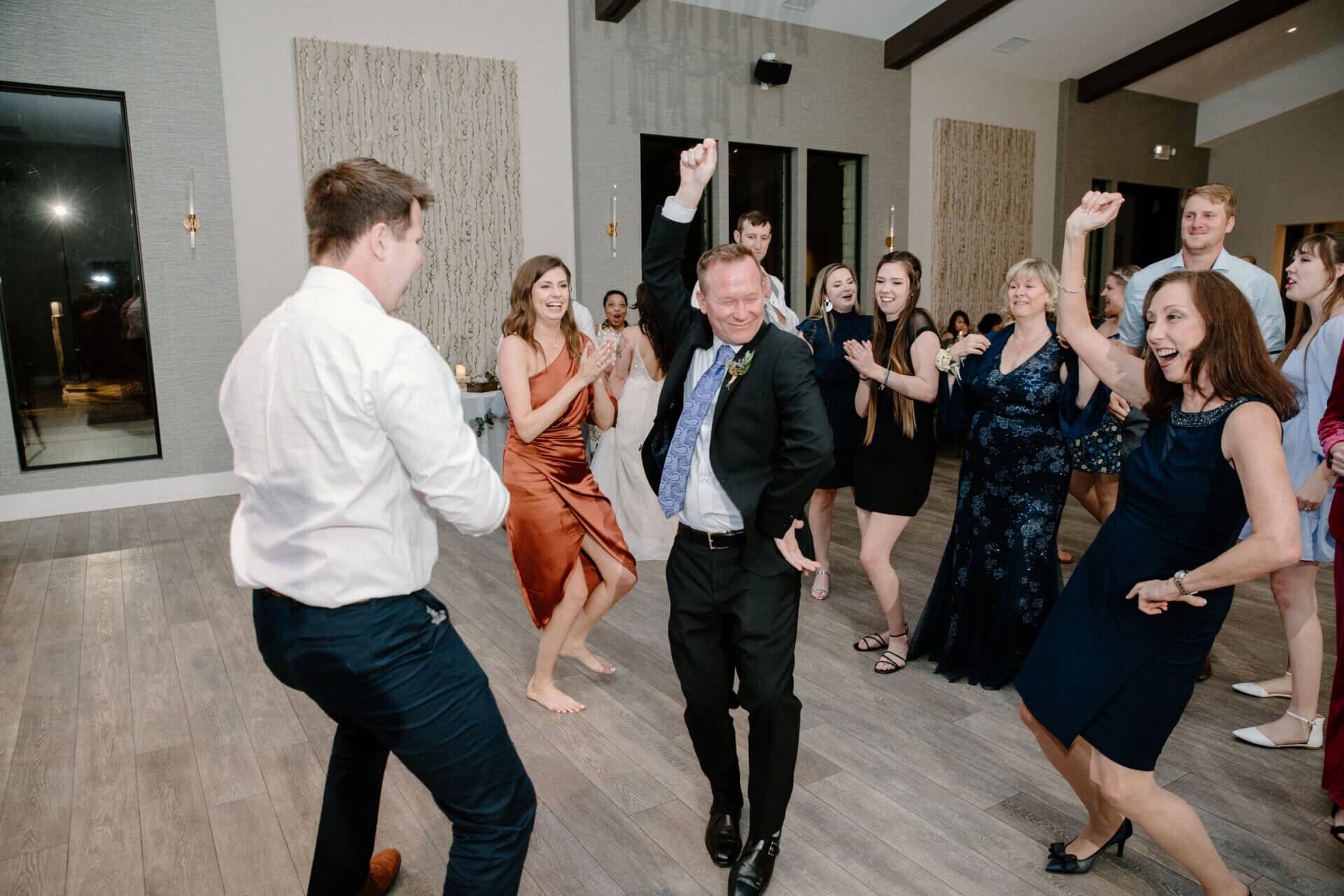 Stonehouse Villa Reception Hall dance floor with wedding guests dancing, Driftwood TX wedding venue